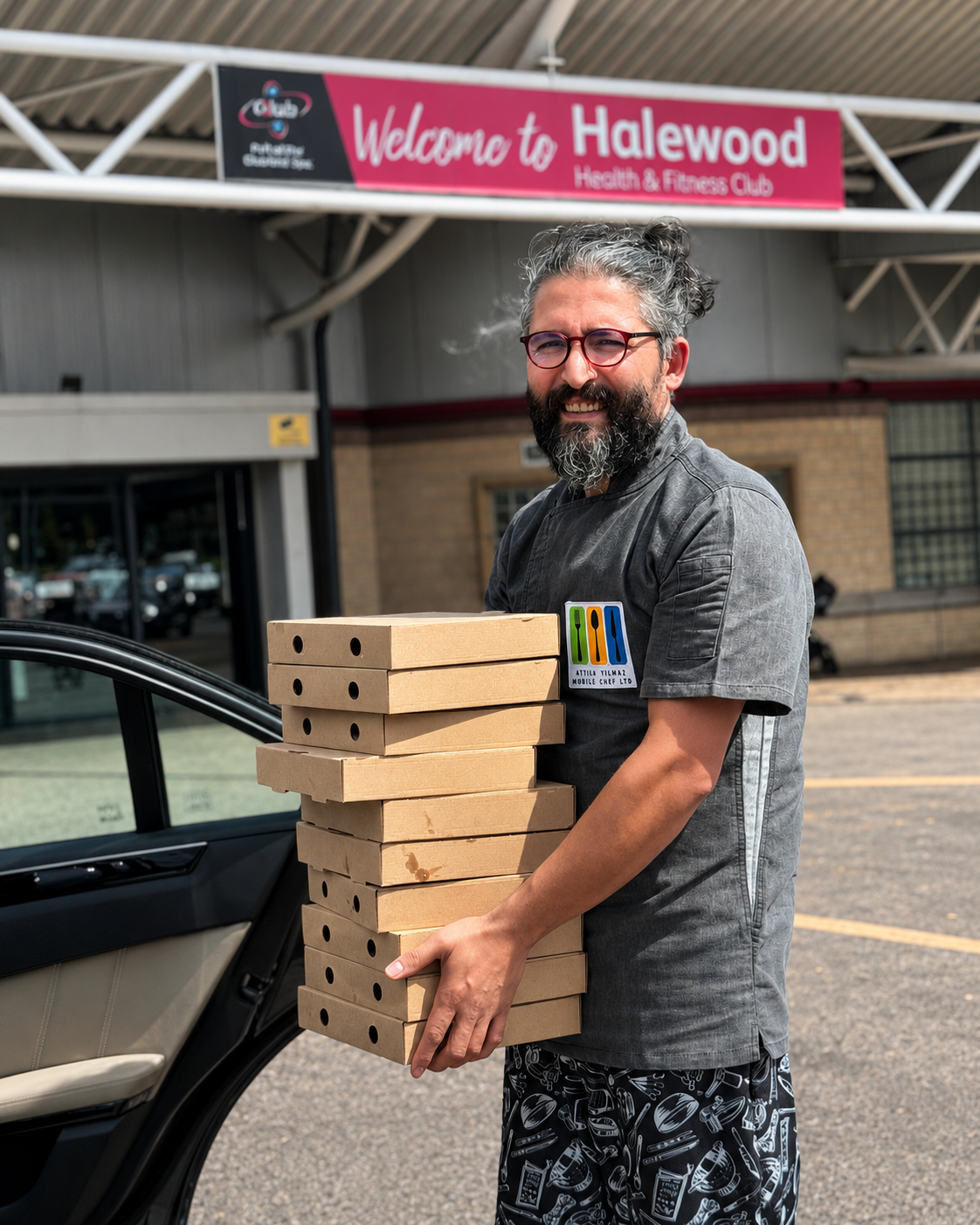 Aytac Yilmaz carrying prepared food boxes outside a venue